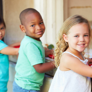 three children in line getting school lunch