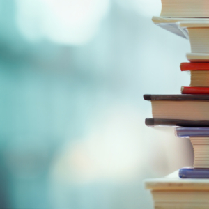 close up of a stack of books with an abstract blue background