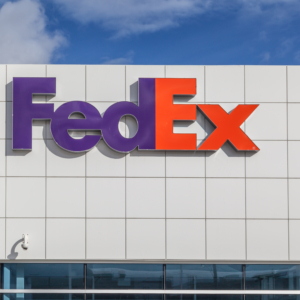 side of a large gray building with a FedEx logo sign