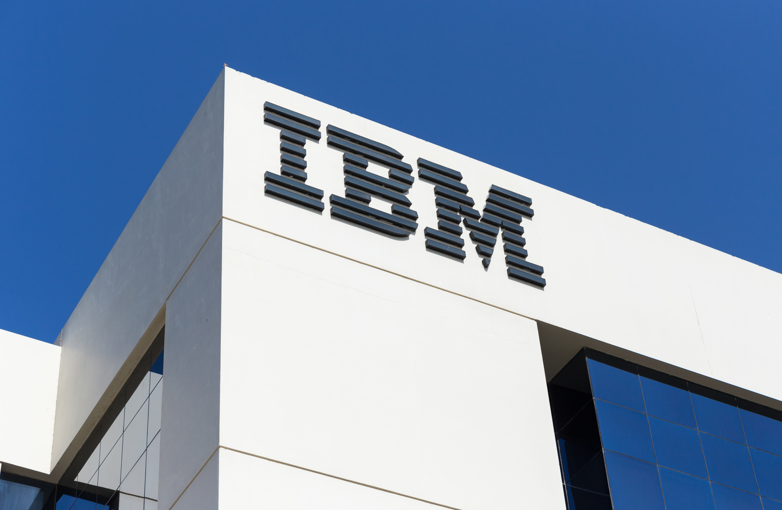 White office building with IBM sign and blue sky